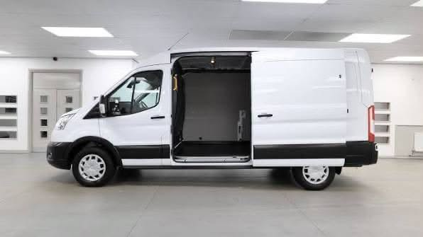 2025 Ford Transit-250 cargo van, side view with the sliding door open on an empty cargo bay.
